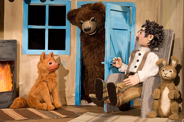 Wanja und Tiere sitzen vor einem Kamin